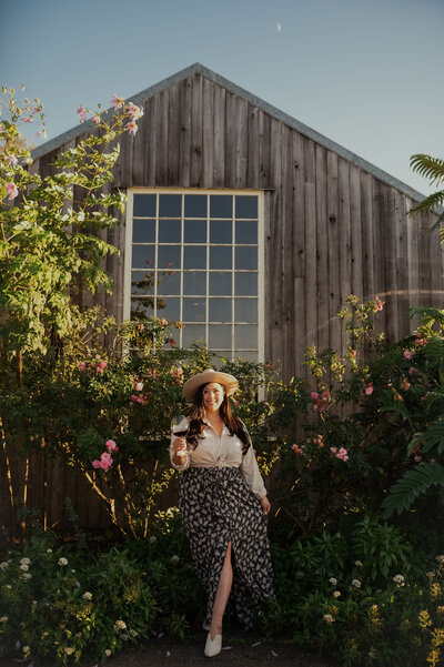 Woman holding glass of wine at winery