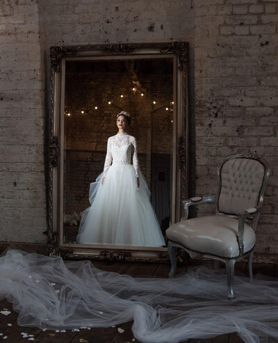 Beautiful bride looking in the mirror