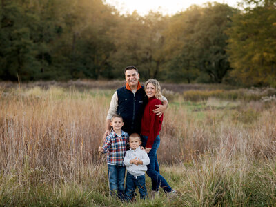 parents with two sons posed at park for family photos Cleveland family photographer
