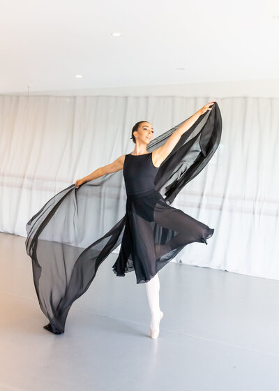 Ballerina in black leotard dancing in studio in Canberra