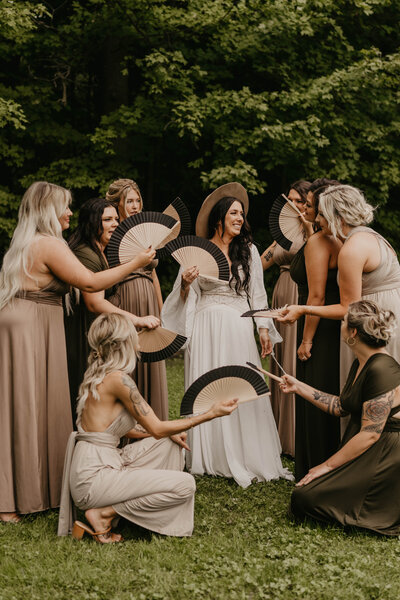 Bridal squad fanning Bride from the summer heat