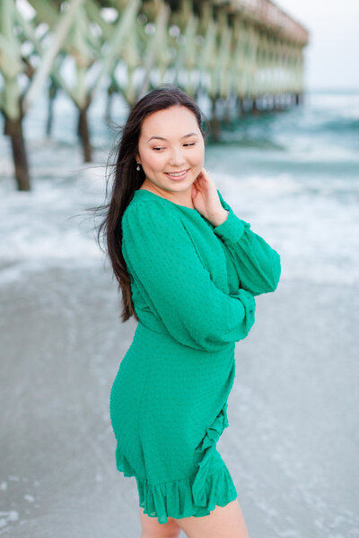 Girl in a green dress on the beach