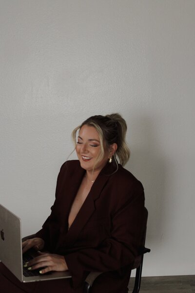 Showcasing a modern and aesthetic website design concept. This image highlights a stylish woman working on a laptop, representing a visually appealing and impactful website design suitable for various creative businesses. See our aesthetic website design portfolio for more high-design examples.