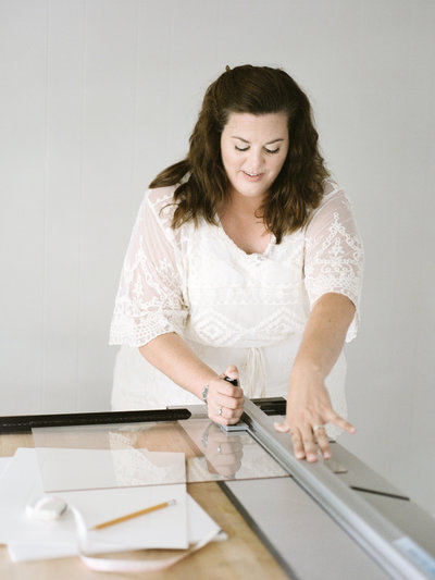 woman cutting glass for picture frame