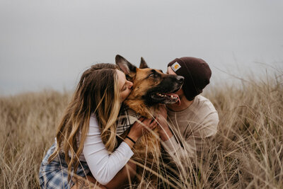 Couple kissing dog