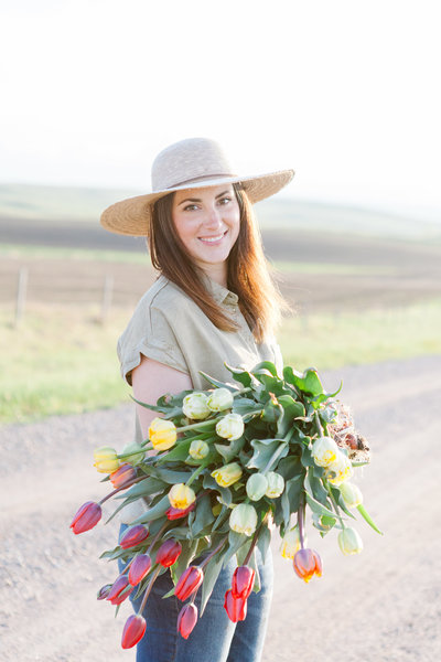 Female entrepreneur with flowers smiling