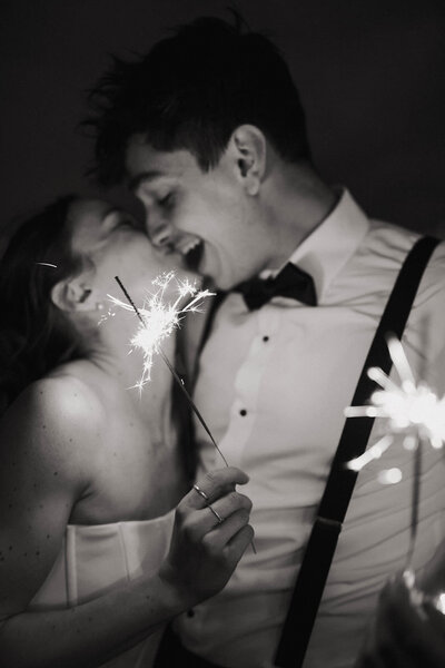 Bride and groom laughing during a sparkler send-off, photographed by a Spokane wedding photographer.
