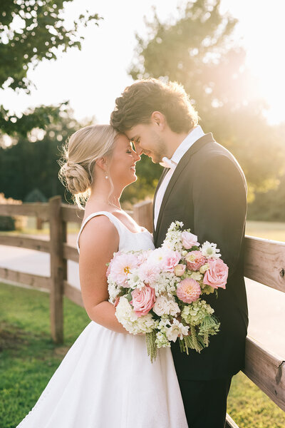 Bride and groom with pink floral bouquet designed by Abby Grace Florals at Anderson SC wedding