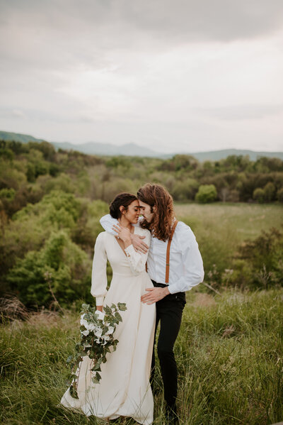 bride and groom boho elopement on the blue ridge parkway in virginia with white flowers and eucalyptus greenery