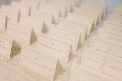White tented escort cards with taupe calligraphy for Greenwich, Connecticut wedding