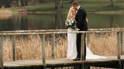 Bride and groom share a quiet moment overlooking the lake at Castle Leslie, captured by Organic Love Story.