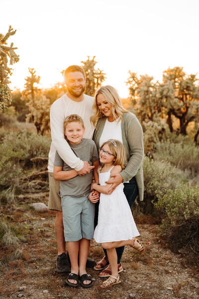 family of four pose in arizona landscape