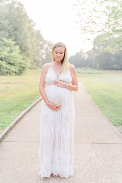 expecting mom looking at belly during maternity photography in Gainesville, VA taken by a Prince William County, Virginia maternity photographer