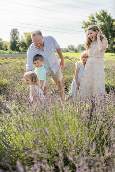 family of five plays in a lavender field together