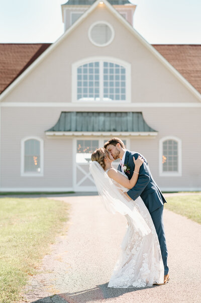 Kentucky bride and groom. Bride and groom kissing in front of Ironwood Farms by Bowling Green, kentucky wedding photographer