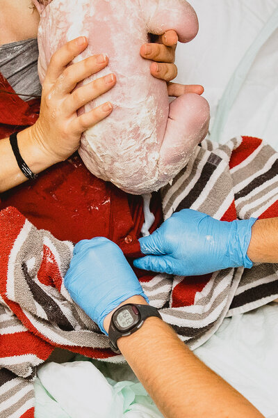 mom and dad cradling thier new arrival