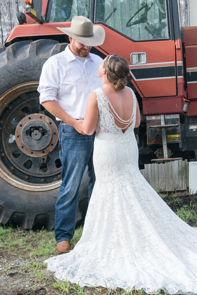 Bride and groom in front of tractor