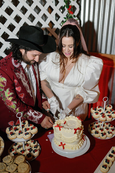 Bride and groom cutting cake at reception planned by Bianca Nichole and Co