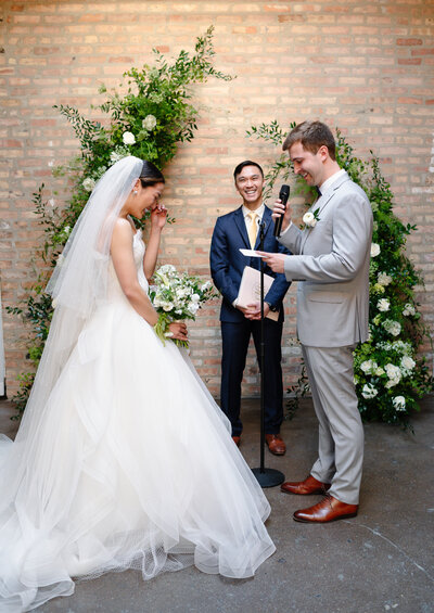 Illinois wedding photographer Melissa Stuckey holding two cameras smiling