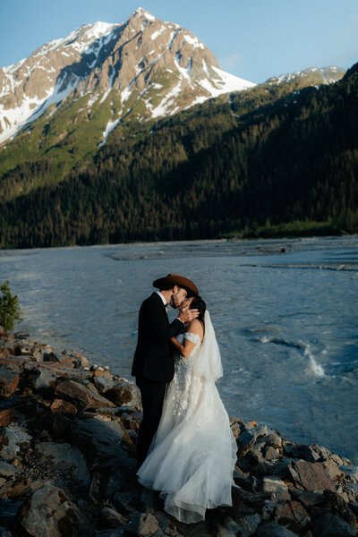 Adventurous couple trekking through a snow-covered Alaskan pass.