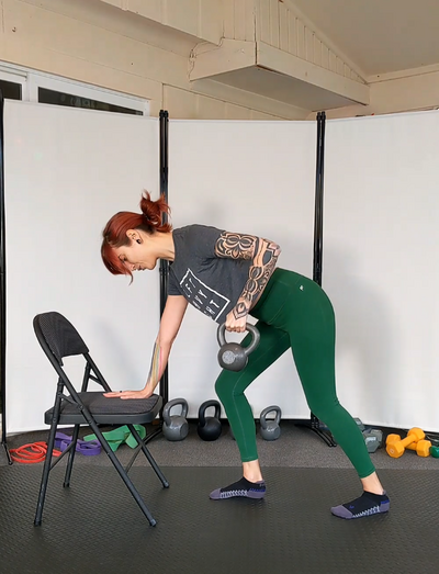 sarah demonstrates a kettlebell supported bent over row for online strength training programs