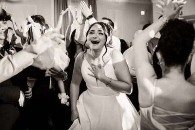 Candid wedding reception photo of laughing bride during grand entrance in New Jersey