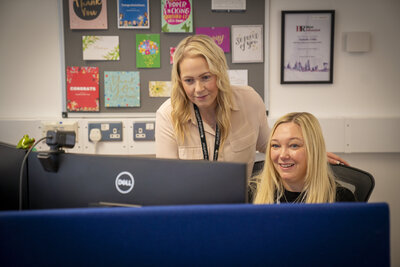 two ladies working at a desk