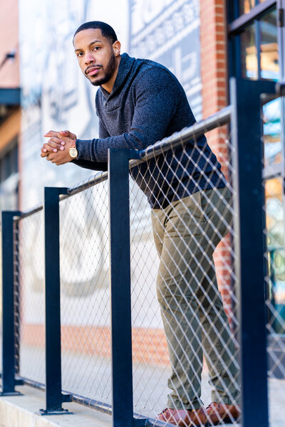 Future groom posing on porch