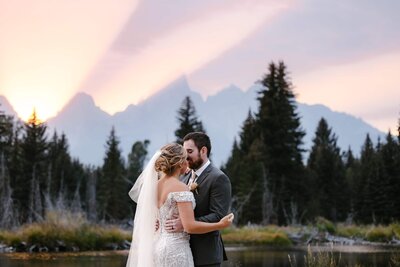 A couple having their first dance at Schwabacher Landing in Grand Teton National Park