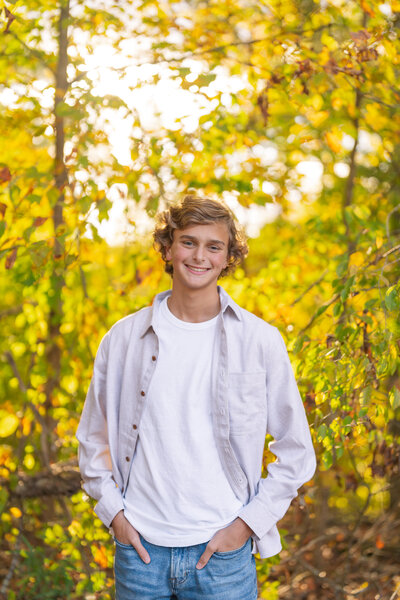 Girl sits on a stool in a field of wildflowers at the Seven Islands State Birding Park.
