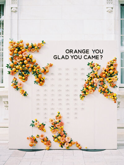 Orange you glad you came escort card display with acrylic cards and citrus arrangements