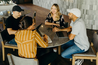 Group of real estate agents sitting at a table and smiling