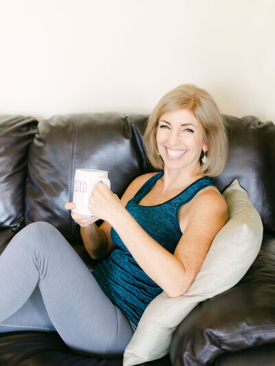 Lora Ulrich smiling at camera sitting at her desk