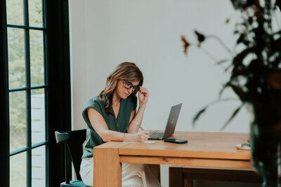 Sam working at her kitchen table