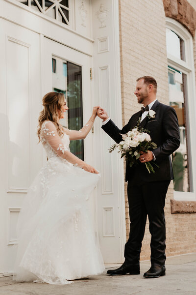 Bride and groom dancing on the street