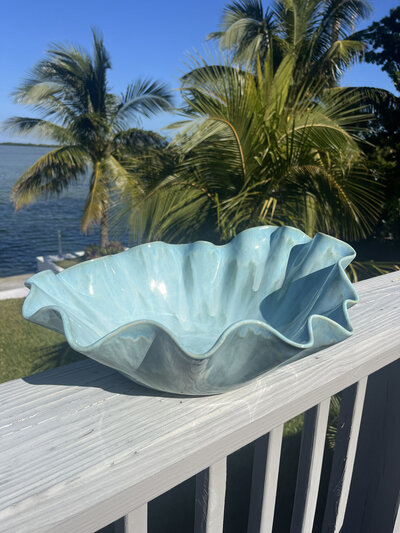 A large green flower vase with textured edges