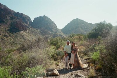 Big Bend photographer documents a heartfelt family moment in the desert mountains of West Texas, using a tripod to capture golden light, cacti, and rugged peaks in the backdrop.