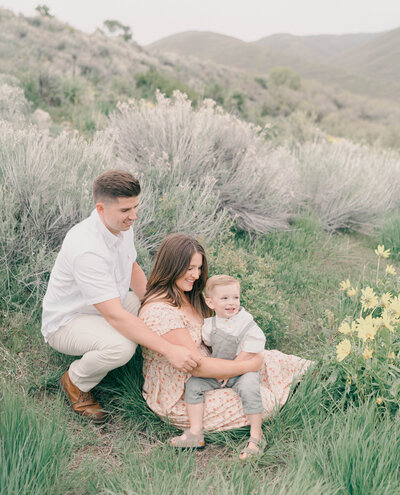 Maternity session in the Utah mountains with parents and toddler, captured in soft light by newborn photographer in Utah