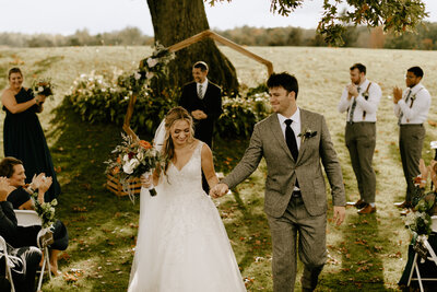 A bride and groom  walking down the aisle after getting married