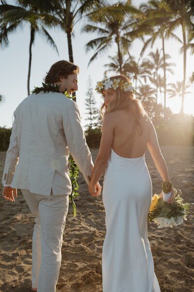 bride and groom holding hands