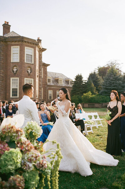 film photo of bride and groom exchanging vows at classy luxury wedding ceremony at Crane Estate in Ipswich, Massachusetts