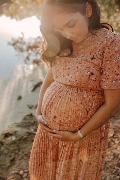 Woman holding belly during Fall Maternity session in Skokie, IL