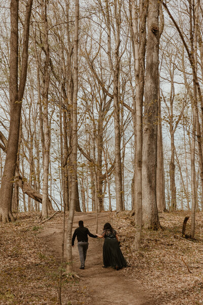 photo of couple walking up a hill holding hands