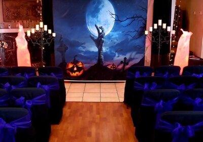 Delight in an event facility transformed into a haunted mansion's wedding scene. Replete with Dracula's candelabra, every changing non hazard flames, a backdrop with a Jack O'Lantern, full moon, and hand coming out of a grave