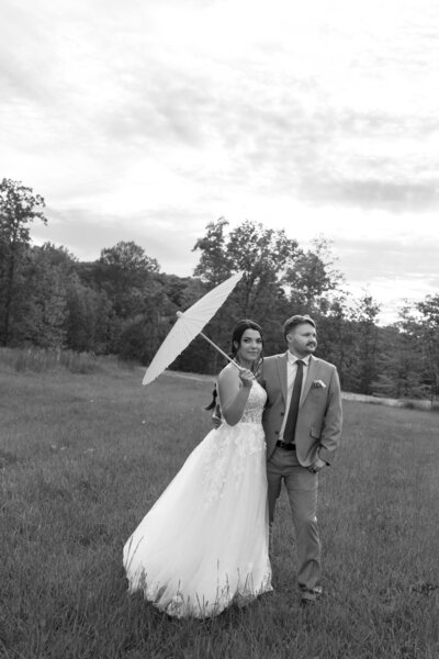 Close-up detail photo of a couple holding up their wedding rings, capturing a meaningful and intimate moment on their Kentucky wedding day.