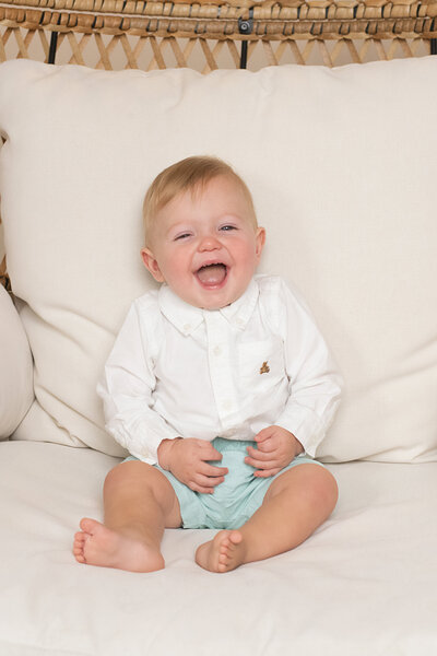 Happy baby smiling in big chair