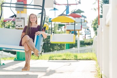a girl sitting on a merry go round