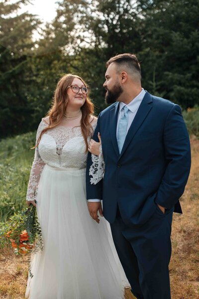 A wedding couple walk along a forest trail in the columbia river gorge in washington state