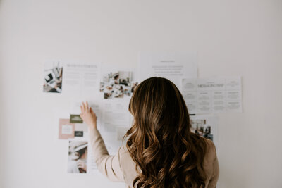 Freelance copywriter Erika Fitzgerald pins website copywriting resources to a whiteboard 