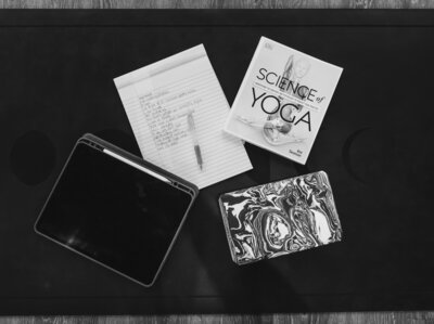 Black and white image of yoga towels sitting in a sound bath bowl next to salt rocks